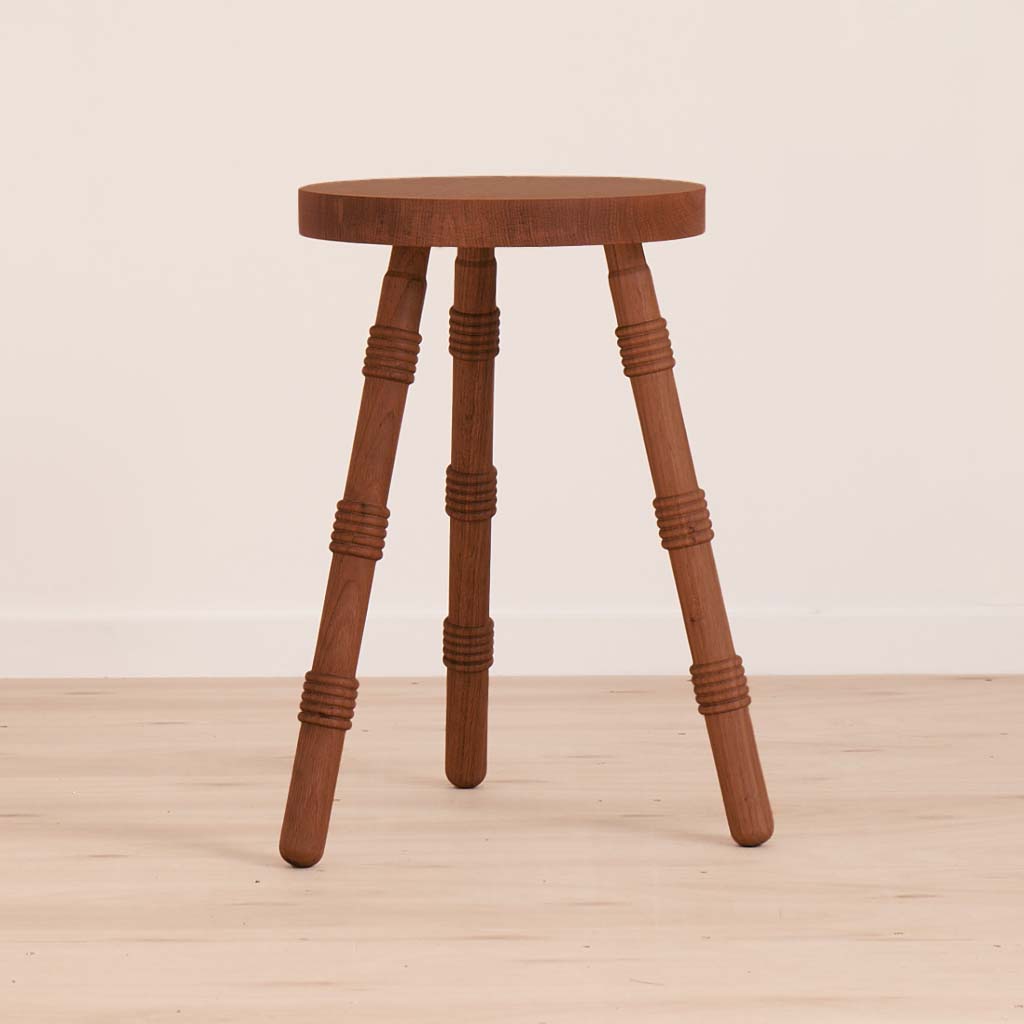 A handmade stool crafted from solid walnut